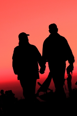 Lovers walk hand-inhand into a sunset. Photo: Arvind Balaraman